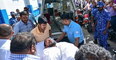 Maamigili MP Qasim Ibrahim carried out from the Criminal Court on a stretcher to the ambulance after he fainted during his hearing. PHOTO: HUSSAIN WAHEED/MIHAARU