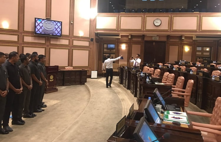 Security officers surround Speaker Maseeh inside the parliament chambers, seen on the left. PHOTO: AHMED NIHAN