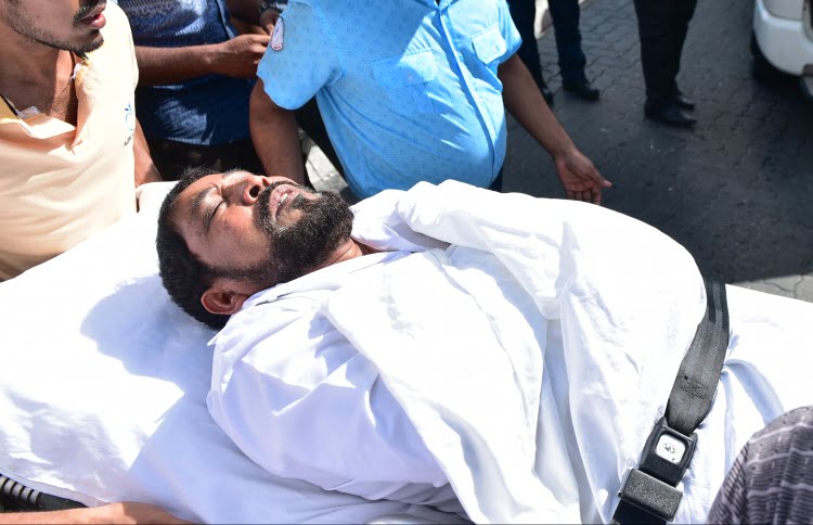 Maamigili MP Qasim Ibrahim carried out from the Criminal Court on a stretcher to the ambulance after he fainted during his hearing. PHOTO: HUSSAIN WAHEED/MIHAARU