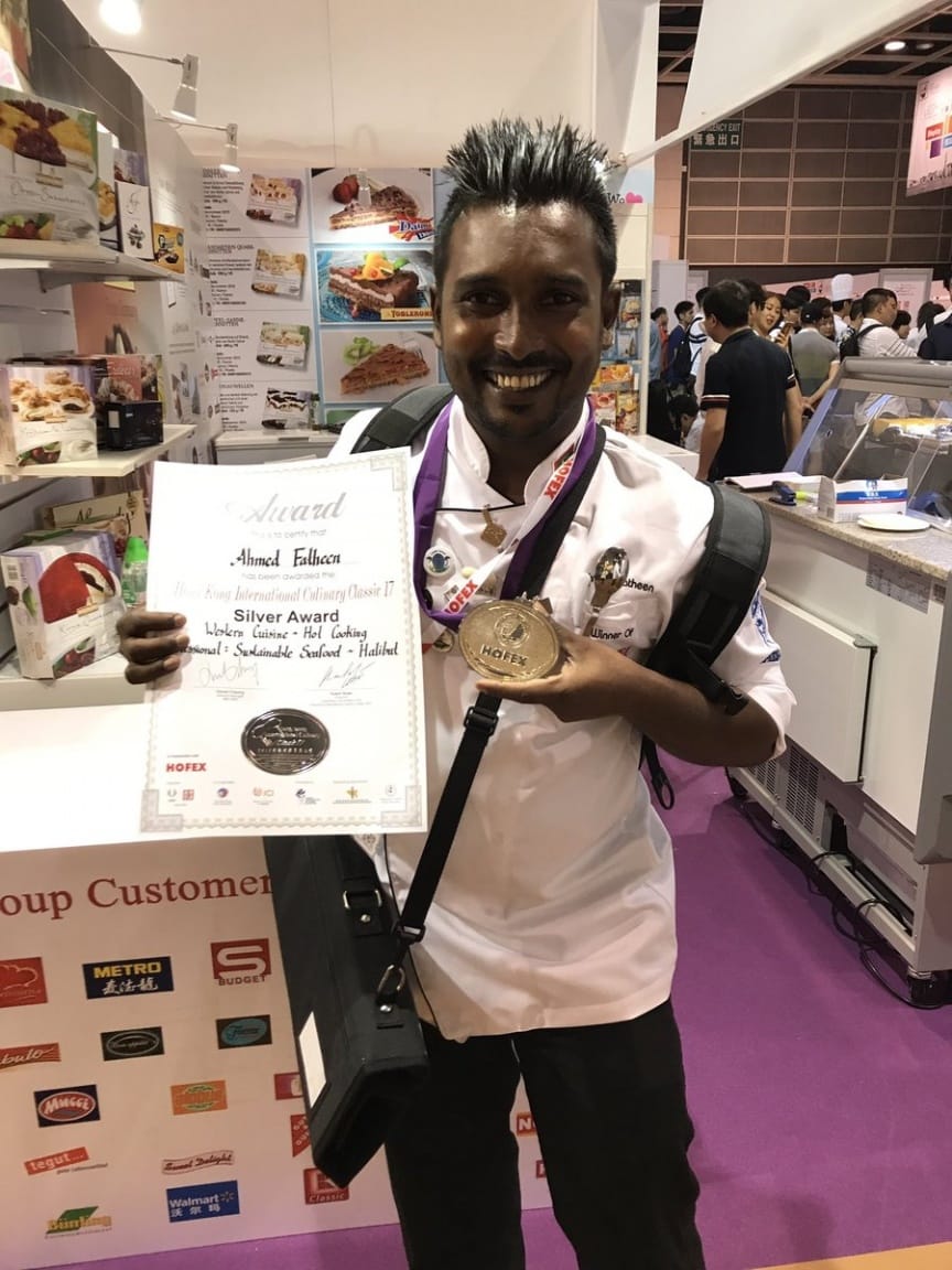 Fatheen showing his award certificate