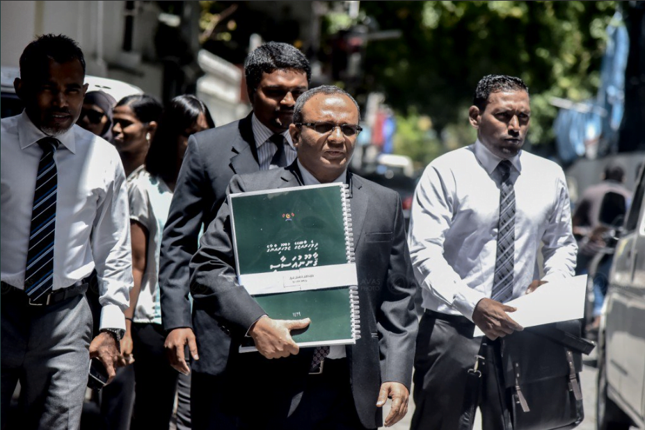Former Attorney General Husnu Al-Suood with the copy of the "big" constitution that was presented to the Attorney General's Office. PHOTO / TWITTER
