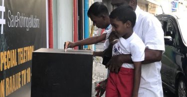 A boy puts money in a fund box placed by Raajje TV to raise aid for the persecuted Rohingya Muslims of Myanmar. PHOTO/TWITTER