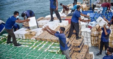 Workers disposing the alcohol and pork that were confiscated by the Maldives Customs. MIHAARU PHOTO / ALI NISHAN