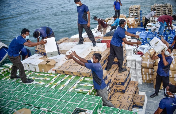 Workers disposing the alcohol and pork that were confiscated by the Maldives Customs. MIHAARU PHOTO / ALI NISHAN