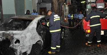 Fire fighters at the scene where Prosecutor General Aishath Bisham's car was torched. PHOTO / MNDF