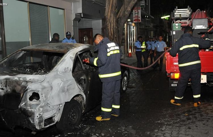 Fire fighters at the scene where Prosecutor General Aishath Bisham's car was torched. PHOTO / MNDF