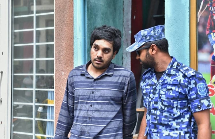 Police arrest Afrah Abdul Razzaq, 21, a suspect wanted in connection to the murder of Mohamed Anas. PHOTO: HUSSAIN WAHEED/MIHAARU