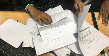 A housing ministry worker handles complaints submitted by the public regarding flat distribution of the government's first social housing project. PHOTO: NISHAN ALI/MIHAARU