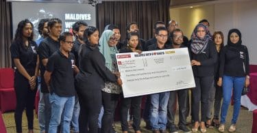 Staff of Raajje TV pose with a check of over MVR 5 million raised by the station to relieve the plight of the Rohingya. PHOTO: HUSSAIN WAHEED/MIHAARU