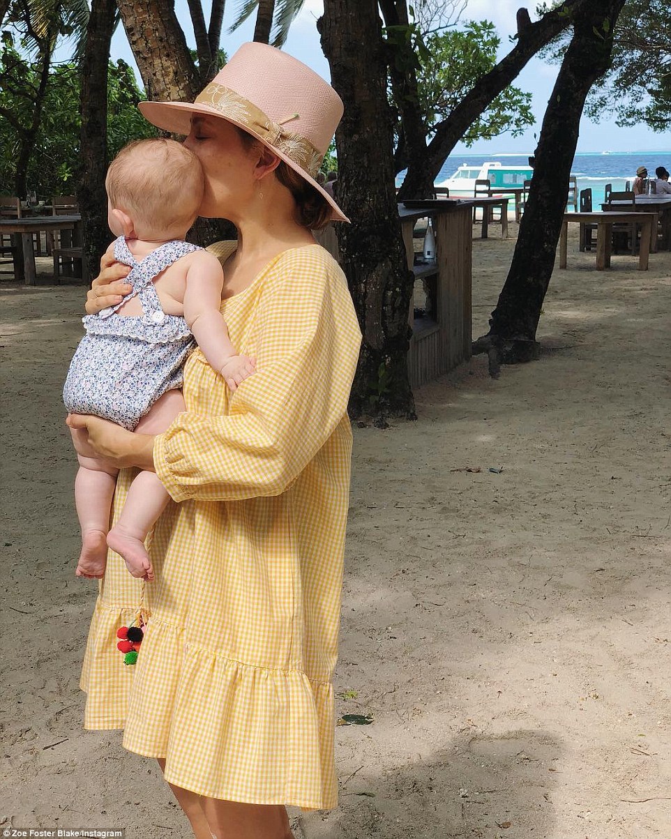 Baby love! Zoe Foster Blake cuddles up to her three-month old daughter Rudy as she continues to enjoy an idyllic $7,000 per-night Maldives work junket with her family