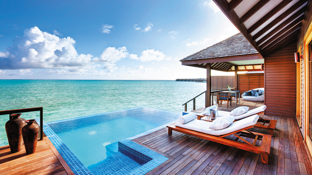 The water villa's sun deck features an infinity pool