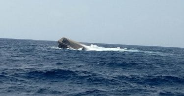 The barge "Kurimagu" of MTCC, carrying 3,300 tonnes of aggregate to HDh Kulhudhuffushi, capsized after it was caught in a storm. PHOTO/READER