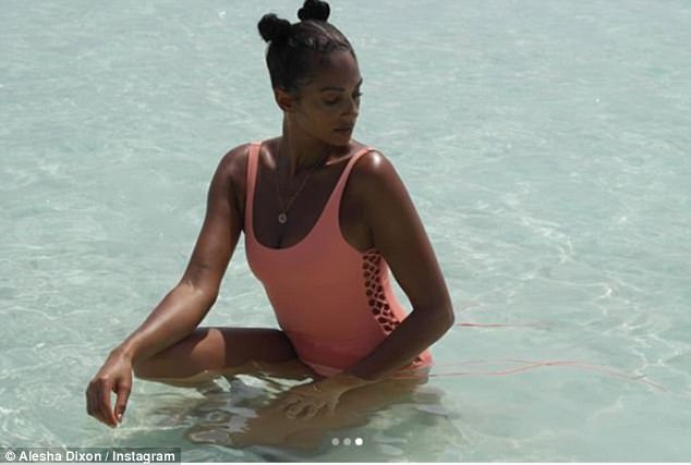 Sizzling hot! With her hair swept into two unique space buns, she opted for minimal makeup as she wore voluminous mascara