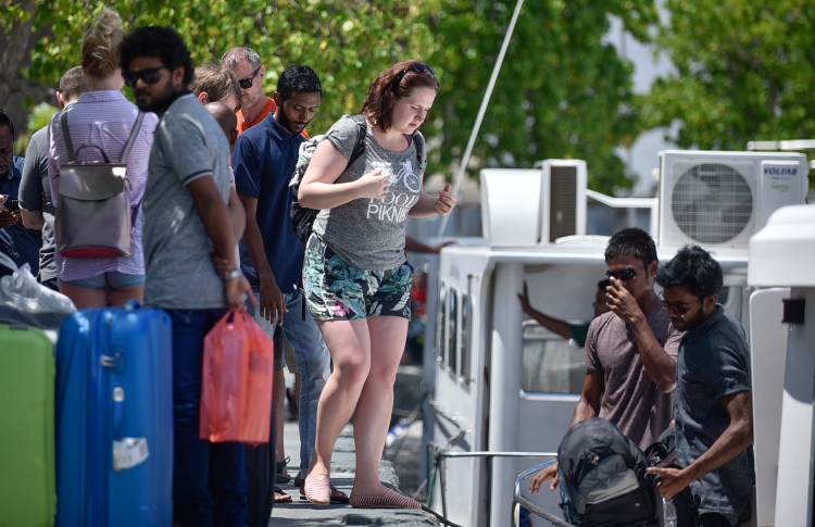 Some tourists boarding a launch to go to the resort