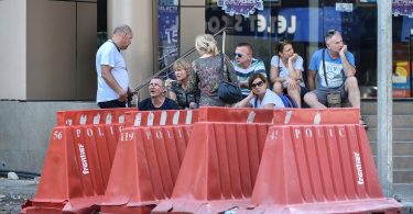 tourists at a police blockade