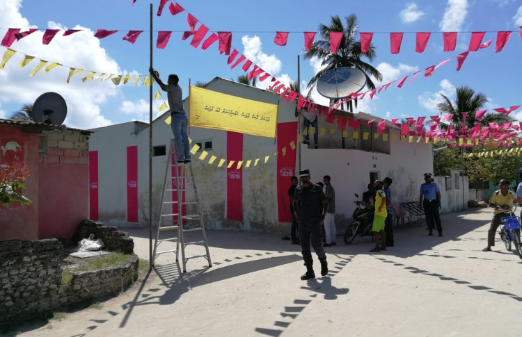 Police removing a campaign banner of MDP in B Atoll Maalhos island